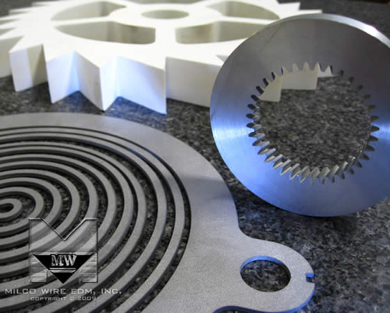 Stainless steel, plastic and aluminum sample prototype parts cut with abrasive waterjet machining, from MILCO Waterjet